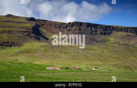 Icelandic landscape. A farm at the foot of a mountain ridge. Stock Photo