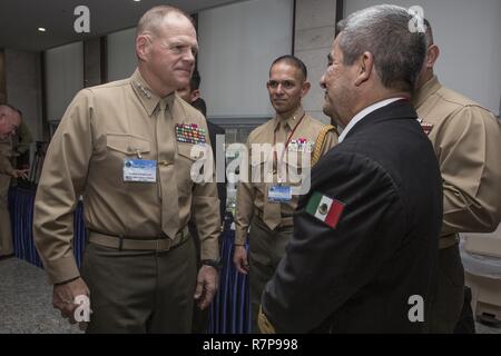 Commandant of the Marine Corps Gen. Robert B. Neller, left, speaks with Vice Adm. Lopez Martinez, coordinator general of the Mexican Naval Infantry, at the Militopia Hotel, Seoul, South Korea, April 1, 2017. Neller visited South Korea to attend the Pacific Amphibious Leaders Symposium 2017. Stock Photo