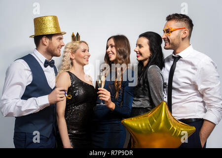 happy friends with golden party props posing Stock Photo