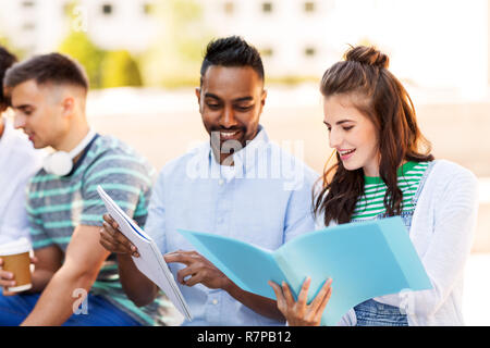 international students with notebooks outdoors Stock Photo