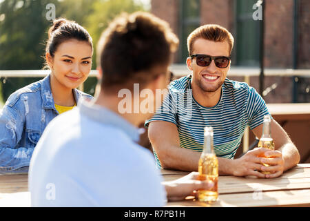 happy friends with drinks at rooftop party Stock Photo