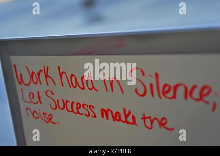 Work hard in silence - let success make the noise. a young businessman  using a cellphone in an office at night Stock Photo - Alamy