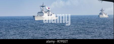 7TH FLEET AREA OF OPERATIONS (March 22, 2017) The Republic of Korea Navy Chungmugong Ti Sun-Shin-Class Destroyer Wanggon (DDH 978) and the Republic of Korea Navy Inchion-Class Frigate Gangwon (FFG 815) transit waters east of the Korean Peninsula during a photo exercise including the United States Navy and the Republic of Korea Navy during Exercise Foal Eagle. The Carl Vinson Carrier Strike Group is on a regularly scheduled Western Pacific deployment as part of the U.S. Pacific Fleet-led initiative to extend the command and control functions of U.S. 3rd Fleet. U.S. Navy aircr Stock Photo