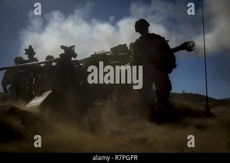 U.S. Marines assigned to Bravo Battery, 1st Battalion, 12th Marine Regiment, operate an M777A2 Lightweight Towed Howitzer during Spartan Fury at the Pohakuloa Training Area, on the big island of Hawaii, March 22, 2017. Spartan Fury is a Battalion level pre-deployment training exercise designed to improve sustainment training for future deployments. Stock Photo