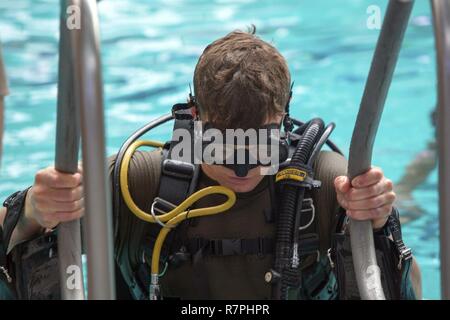 Sgt. Brian Rogan exits the pool after conducting dive training at Camp Lejeune, N.C., March 23, 2017. The Marines trained with the self-contained underwater breathing apparatus to maintain proficiency and confidence in their combat diving skills. Rogan is a reconnaissance Marine with 2nd Reconnaissance Battalion, 2nd Marine Division. Stock Photo