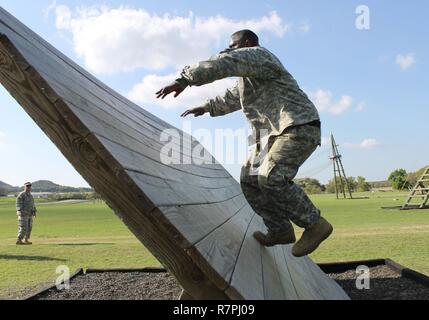 Army Reserve Staff Sgt. Vanqualis Battles, 1st  Brigade, 98th Training Division (Initial Entry Training), clears the inverted wall obstacle on March 21 during the 108th Training Command (IET) 2017 Best Warrior Competition at Camp Bullis, Texas. Stock Photo