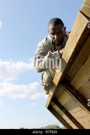 Army Reserve Staff Sgt. Vanqualis Battles, 1st  Brigade, 98th Training Division (Initial Entry Training), clears the inverted wall obstacle on March 21 during the 108th Training Command (IET) 2017 Best Warrior Competition at Camp Bullis, Texas. Stock Photo