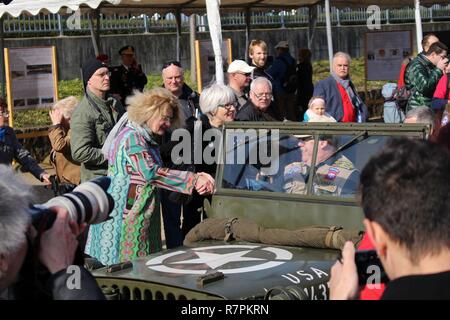 Catherine Rommel, left, the granddaughter of German Field Marshall Erwin Rommel, and Helen Patton, the granddaughter of U.S. Army Gen. George Patton, greet reenactors along the Rhine River Saturday, March 24, 2017 in Nierstein Germany. Americans and Germans gathered for the dedication ceremony for a monument to the 249th Engineer Combat Battalion’s efforts at the end of World War II, building a bridge across the river near Nierstein during an operation that helped shorten the war. Stock Photo