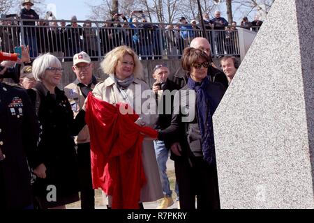 Helen Patton, left, the granddaughter of U.S. Army Gen. George Patton; Catherine Rommel, center, the granddaughter of German Field Marshall Erwin Rommel; Luci Schey, president of the Ralph and Luci Schey Foundation, examine a memorial to the Soldiers of the 249th Engineer Combat Battalion Saturday, March 24, 2017 in Nierstein Germany. Stock Photo