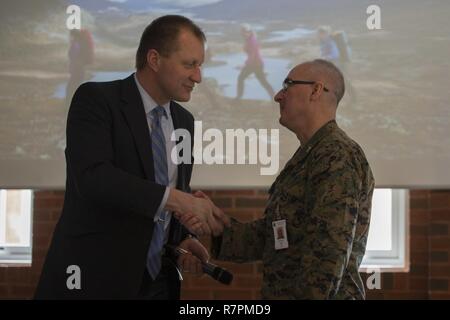 Deputy Mayor of Stjørdal, Ole Hermod Sandvik, shakes hands with U.S. Marine Col. Doug Bruun, Marine Corps liaison to Norway, at Vaernes Garnison, Norway, March 28, 2017. Sandvik served in the Norwegian Armed Forces for 22 years, some of which he served at the Home Guard 12 base where Marine Rotational Force Europe 17.1 is now deployed. Stock Photo