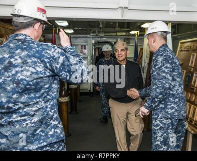 YOKOSUKA, Japan (March 23, 2017) Vice Adm. Herman A. Shelanski, center, Naval Inspector General, is greeted by Rear Adm. Charles Williams, right, commander, Task Force 70, and Capt. Buzz Donnelly, left, commanding officer of the Navy's only forward-deployed aircraft carrier, USS Ronald Reagan (CVN 76), on the ship’s ceremonial quarterdeck. Shelanski toured the ship as part of his area visit of Commander, Navy Region Japan. Ronald Reagan, the flagship of Carrier Strike Group 5, provides a combat-ready force that protects and defends the collective maritime interests of its allies and partners i Stock Photo