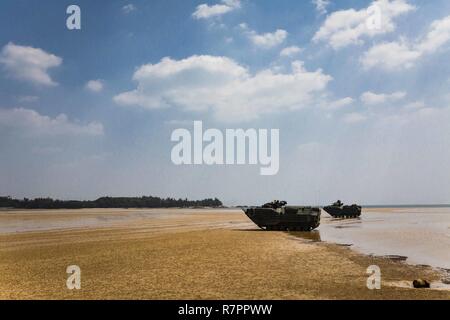 AAV-P7/A1 assault amphibious vehicles with Echo Co., Battalion Landing Team, 2nd Battalion, 5th Marines, 31st Marine Expeditionary Unit, assist in posting security on a beach while participating in mechanized raid at Marine Corps Base Butler, Okinawa, Japan, March 27, 2017. As the Marine Corps' only continuously forward-deployed unit, the 31st MEU air-ground-logistics team provides a flexible force, ready to perform a wide range of military operations, from limited combat to humanitarian assistance operations, throughout the Indo-Asia Pacific region. Stock Photo