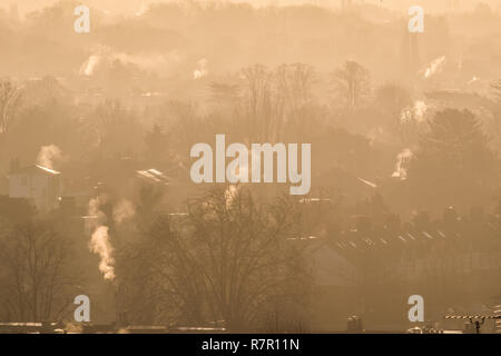 London UK. 11th December 2018. UK Weather: Steam billows from rooftops bathed in beautiful winter sunshine over Wimbledon Credit: amer ghazzal/Alamy Live News Stock Photo