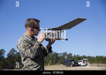 Sgt. Dillon Emery checks a Raven small unmanned aircraft system’s components to ensure it is ready to fly at Camp Lejeune, N.C., March 27, 2017. Marines conducted aerial training exercises at Tactical Landing Zone Dove to demonstrate the capabilities and build familiarization with the SUAS. Emery is an intelligence specialist with 2nd Battalion, 8th Marine Regiment. Stock Photo