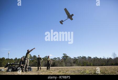 A Marine launches a Raven small unmanned aircraft system into the air at Camp Lejeune, N.C., March 27, 2017. Marines conducted aerial training exercises at Tactical Landing Zone Dove to demonstrate the capabilities and build familiarization with the SUAS. The Marines are intelligence specialists with 2nd Battalion, 8th Marine Regiment. Stock Photo