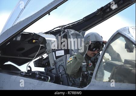U.S. Air Force Capt. Chad Rudolph, 357th Fighter Squadron and A-10 West Heritage Flight Team pilot, puts on his goggles before takeoff during the Los Angeles County Air Show in Lancaster, Calif., March 25, 2017. This is the team’s first air show performance after nearly five years of disbandment. Stock Photo