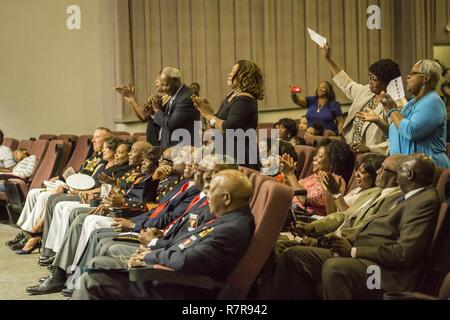 Guests applaud a performer during the National Montford  Point Association’s Congressional Gold Medal presentation  hosted by Marine Corps Air Station Beaufort, March 25. Several musicians and groups preformed tribute songs to honor the Jameson family who accepted the medal on behalf of the late Willis Jameson. Stock Photo