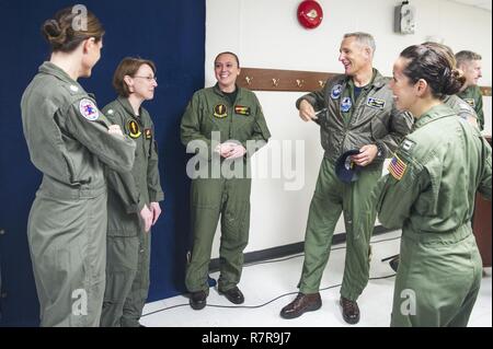 NORFOLK (March 29, 2017) Capt. Timothy Kuehhas, center, the commanding officer aboard the aircraft carrier USS George Washington (CVN 73), meets with members of the Navy's first all-female E-2C Hawkeye combat mission after the ship's women's history month observance event. The members were invited to the ship's event as distinguish guests. George Washington is homeported in Norfolk preparing to move to Newport News, Virginia for the ship’s refueling complex overhaul (RCOH) maintenance. Stock Photo