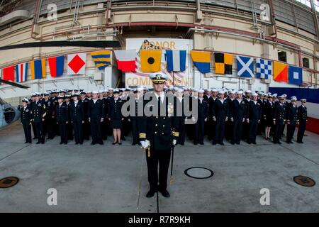 NAVAL AIR FACILITY ATSUGI, Japan (March 30, 2017) Helicopter Sea Combat Squadron (HSC) 12 Executive Officer Cmdr. Jose A. Arana, from Orlando, Fla., calls Sailors to attention during a change of command ceremony in the squadron’s hangar. During the ceremony, Cmdr. Benjamin Van Buskirk, from Menlo Park, Calif. relieved Cmdr. Ralph L. McQueen III, from San Diego, as commanding officer of HSC-12. Stock Photo