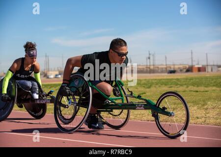 U.S. Army veteran, Jarred Vaina, conducts practices laps on the racing wheelchair for the Warrior Care and Transition's Army Trials at Fort Bliss Texas, March 30, 2017. About 80 wounded, ill and injured active-duty Soldiers and veterans are competing in eight different sports 2-6 April for the opportunity to represent Team Army at the 2017 Department of Defense Warrior Games. Stock Photo