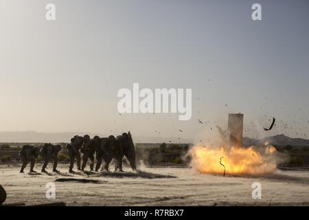 Marines take cover behind one of their medium tanks while cleaning out ...