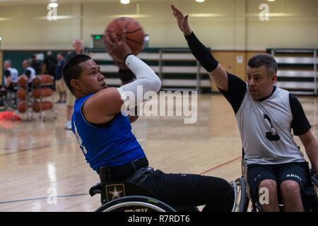 U.S. Army veteran, Jarred Vaina, engages in a simulated game of wheelchair basketball for the Warrior Care and Transition's Army Trials at Fort Bliss Texas, March 31, 2017. About 80 wounded, ill and injured active-duty Soldiers and veterans are competing in eight different sports 2-6 April for the opportunity to represent Team Army at the 2017 Department of Defense Warrior Games. Stock Photo