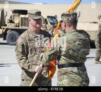 Outgoing 17th Sustainment Brigade commander Vernon L. Scarbrough hands the unit colors to Brig. Gen. Michael Hanifan, Nevada Commander Army Guard, during a change of command ceremony at the North Las Vegas Readiness Center, April 2, 2017. Col. Eric G. Wishart assumed command from Scarbrough to become the fourth commander in the history of 17SB. Stock Photo