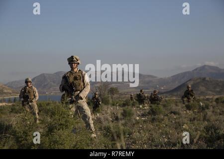 U.S. Marines assigned to Special Purpose Marine Air Ground Task Force-Crisis Response-Africa wait to move to an objective area during a bilateral Military Operation on Urbanized Terrain exercise with the Spanish 2nd Special Operations Group “Granada” in Alicante, Spain, March 29, 2017. The exercise provided an opportunity for Marines and Spanish SOF members to improve interoperability, maintain joint readiness and strengthen relationships. Stock Photo