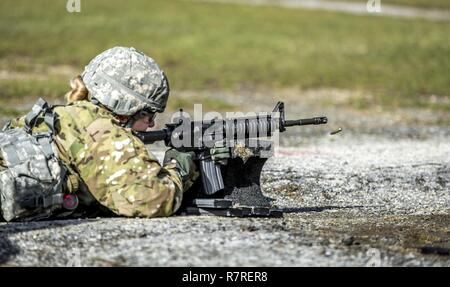 U.S. Army Spc. Courtney Natal zeroes her weapon before shooting a weapon qualification during the New York Army National Guard Best Warrior Competition at Camp Smith Training Site March 30, 2017. The Best Warrior competitors represent each of New York's brigades after winning competitions at the company, battalion, and brigade levels. Stock Photo