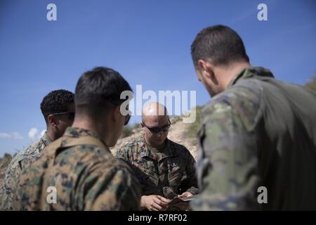 Staff Sgt. Khalid Al-Abid, an Explosive Ordnance Disposal Team Leader assigned to Special Purpose Marine Air Ground Task Force-Crisis Response-Africa, explains the properties of a C-1 deta sheet during a bilateral training exercise with Spanish 2nd Special Operations Group “Granada” members at Agost, Alicante, Spain, March 28, 2017. The training exercise allowed Marines and Spanish SOF members to share tactics and explosive capabilities, further enhancing interoperability and advancing shared goals when working together as allies. Stock Photo