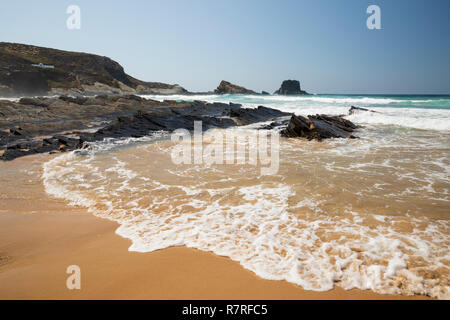 Atlantic waves breaking on sandy beach in the morning sun, Zambujeira do Mar, Alentejo region, Portugal, Europe Stock Photo