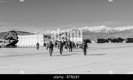 U.S. Army Soldiers assigned to 1st Squadron, 14th Cavalry Regiment, 1st Stryker Brigade Combat Team, 2nd Infantry Division exit a CH-47 Chinook helicopter assigned to Task Force Flying Dragon, 16th Combat Aviation Brigade, 7th Infantry Division during training at Bagram Airfield, Afghanistan, April 1, 2017. The Cavalry troopers provide a ready response force for downed aircraft, and the training focused on preparing them to assume their mission in support of Operation Freedom’s Sentinel and Resolute Support Mission. Stock Photo