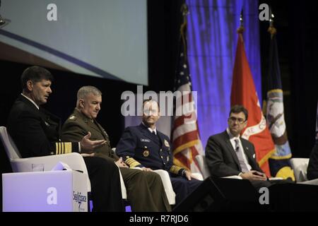 NATIONAL HARBOR, Md. (April 3, 2017) Vice Chief of Naval Operations (VCNO) Vice Adm. William Moran, left, speaks at the 2017 Sea, Air and Space Exposition. Moran was joined by a panel including Assistant Commandant of the U.S. Marine Corps Gen. Glenn Walters, Vice Commandant of the U.S. Coast Guard Adm. Charles Michel, and Joel Szabat, executive director of Maritime Transportation, to discuss a “Sea Services Update” regarding today's maritime environment. The annual event, founded in 1965, is the largest maritime exposition in the U.S. and brings together key military decision makers, U.S. def Stock Photo