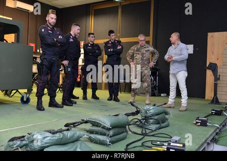Joseph Gallegos, Training Specialist, Training Support Center Italy, shows the Engagement Skills Trainer (EST) to the Italian Carabinieri of the 13th Regiment Carabinieri “ Friuli Venezia Giulia” Gorizia, during the training at Caserma Ederle, April 3, 2017, Vicenza, Italy. Carabinieri use U.S. Army RTSD South equipment to enhance bilateral relations and to expand levels of cooperation and the capacity of the personnel involved in joint operations.