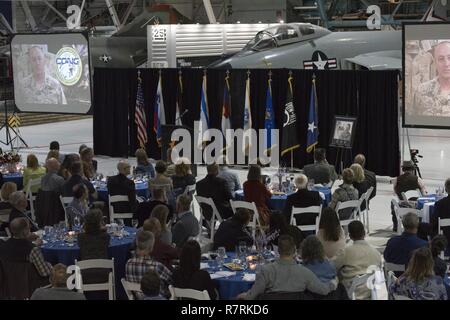 An audience watches a video dedicated to United States Air Force Maj. Gen. H. Michael Edwards, The Adjutant General of Colorado in celebration of his retirement from the Colorado Air National Guard at the Wings Over the Rockies Air & Space Museum, Denver Colo., April 2, 2017.   Maj. Gen. Edwards devoted 43-years of service to the United States Air Force. (Air National Guard Stock Photo