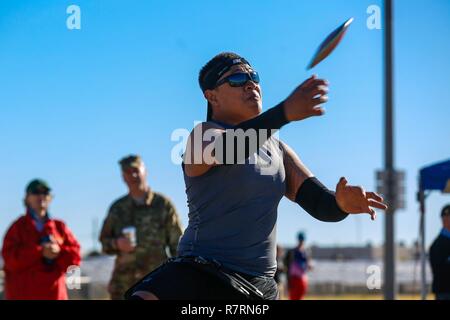 U.S. Army veteran, Jarred Vaina, throws in the sitting discus event for the Warrior Care and Transition's Army Trials at Fort Bliss Texas, April 5, 2017. About 80 wounded, ill and injured active-duty Soldiers and veterans are competing in eight different sports 2-6 April for the opportunity to represent Team Army at the 2017 Department of Defense Warrior Games. Stock Photo