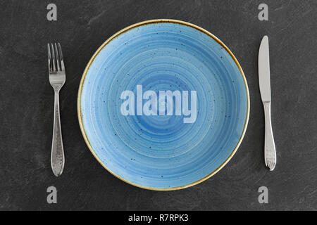 close up of plate, fork and knife on table Stock Photo