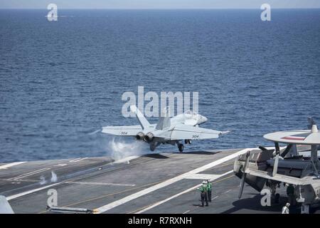 ARABIAN GULF (April 6, 2017) An F/A-18E Super Hornet attached to the 'Golden Warriors' of Strike Fighter Squadron (VFA) 87 launches from the flight deck of the aircraft carrier USS George H.W. Bush (CVN 77) (GHWB). GHWB is deployed in the U.S. 5th Fleet area of operations in support of maritime security operations designed to reassure allies and partners, and preserve the freedom of navigation and the free flow of commerce in the region. Stock Photo