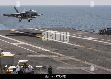 ARABIAN GULF (April 6, 2017) An F/A-18E Super Hornet attached to the 'Tomcatters' of Strike Fighter Squadron (VFA) 31 lands on the aircraft carrier USS George H.W. Bush (CVN 77) (GHWB). GHWB is deployed in the U.S. 5th Fleet area of operations in support of maritime security operations designed to reassure allies and partners, and preserve the freedom of navigation and the free flow of commerce in the region. Stock Photo