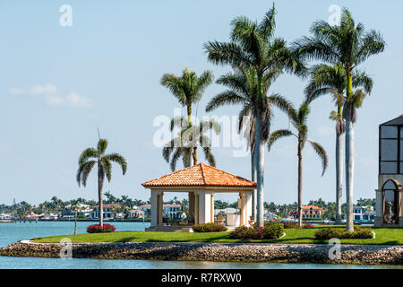 Naples, USA - April 30, 2018: Bayfront bay bayview park residential community with water, palm trees, gazebo pavilion in Florida Stock Photo