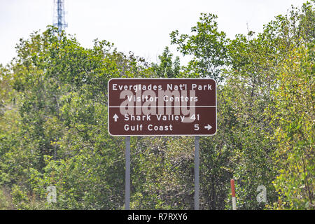 Sign for Everglades National Park Visitor Center and Shark Valley Gulf Coast in Florida street road highway, green trees Stock Photo