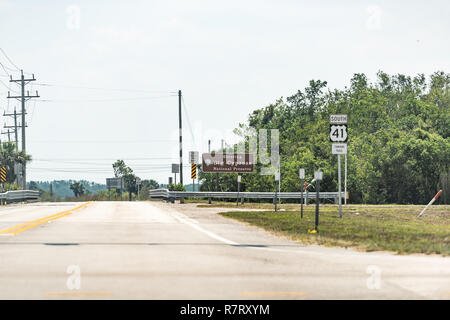 Sign for Everglades National Park Visitor Center and Big Cypress Preserve in Florida street road highway, green trees Stock Photo