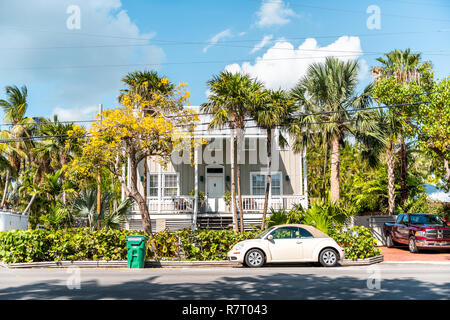 Key West, USA - May 1, 2018: Typical architecture of houses in Florida city island on travel, sunny day, street property real estate, retro car Stock Photo