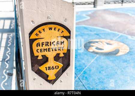 Key West, USA - May 1, 2018: African Cemetery sign by pier park with nobody in Florida sunny day street closeup of memorial for Africans at Higgs Beac Stock Photo