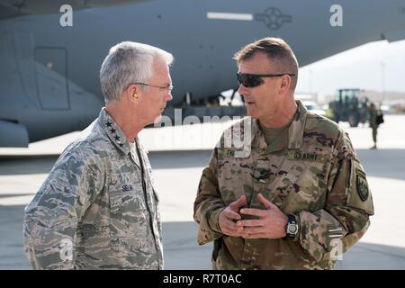 U.S. Air Force Gen. Paul J. Selva, Vice Chairman of the Joint Chiefs of Staff, speaks with U.S. Army Maj. Gen. John C. Thomson III, 1st Cavalry Division Commanding General, upon arrival at Bagram Airfield, Afghanistan, March 30, 2017. Gen. Selva, along with USO entertainers, visited service members who are stationed outside the continental U.S. at various locations across the globe.  This year’s entertainers included country musician Craig Morgan, mixed-martial artist Dominick Cruz, chef Robert Irvine, U.S. Olympic Swimmer Katie Meili, and mentalist Jim Karol. Stock Photo