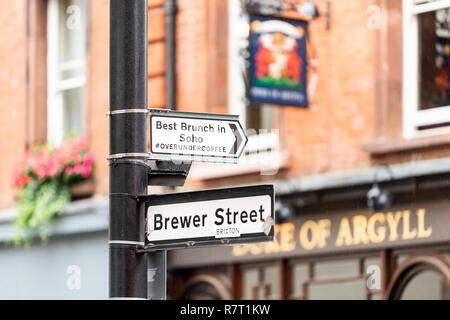 London, UK - September 12, 2018: Closeup of famous Brewer Market Street sign with best brunch in Soho overundercoffee hashtag, brixton, and pub called Stock Photo