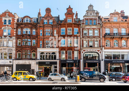 London, UK - September 13, 2018: Neighborhood district of Knightsbridge brick architecture, road, cars in street traffic on sunny day Stock Photo