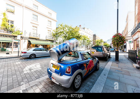 London, UK - September 13, 2018: Neighborhood district of Belgravia with street, car and sign for red bull energy drink parked on road Stock Photo