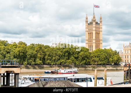 London, UK - September 14, 2018: Cityscape skyline of city with Thames River, Westminster during cloudy overcast autumn, cruises boat on Albert Embank Stock Photo