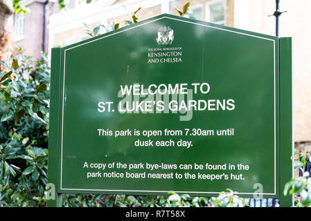 London, UK - September 16, 2018: Closeup of green St Luke's Gardens Park sign in Chelsea, nobody, hours and welcome Stock Photo